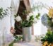 Florist arranges a colorful bouquet in a bright indoor workspace, showcasing floral artistry.